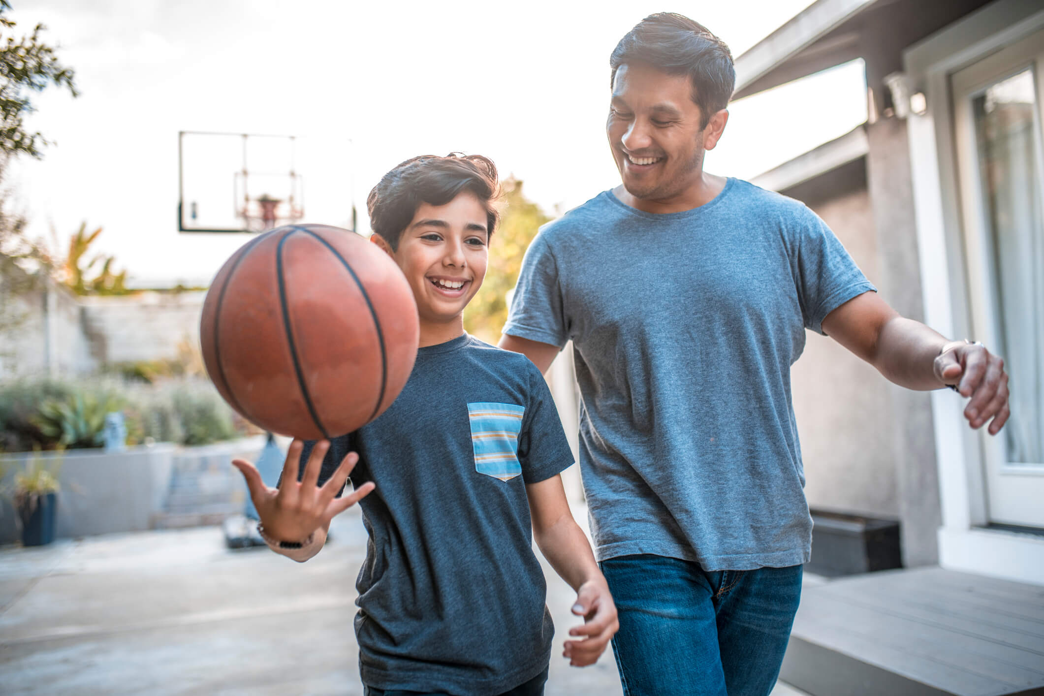 Single father and son playing basketball.