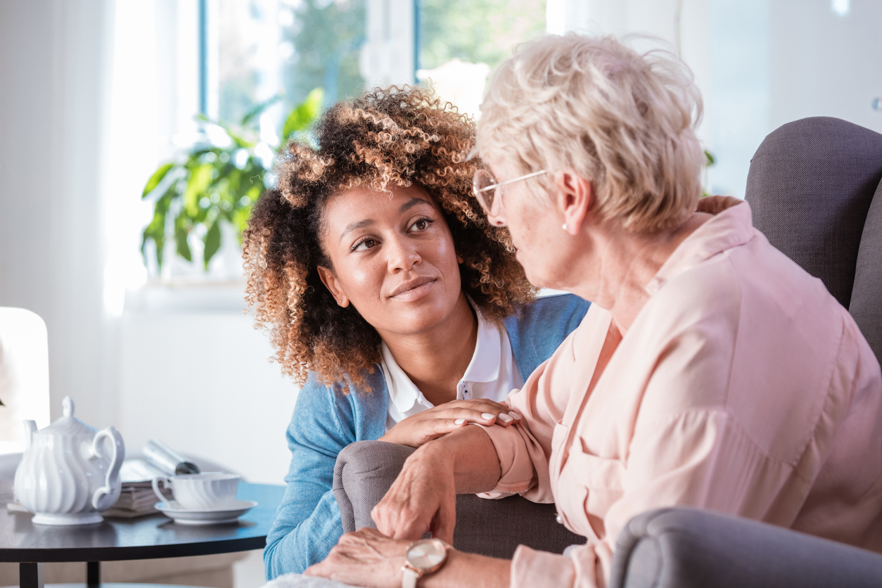 elder woman with alzheimer's talking to caregiver