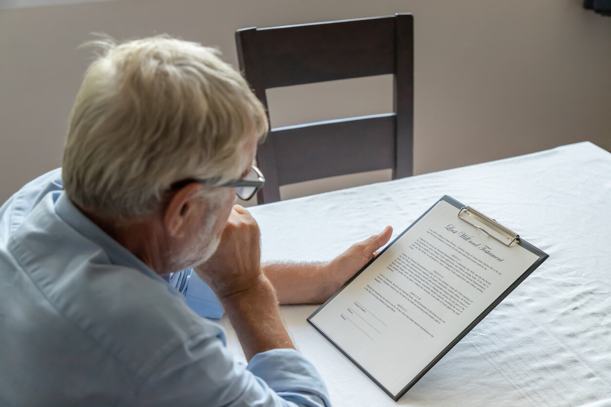 elderly man looking over estate planning document
