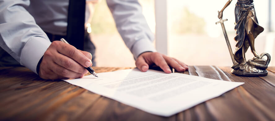 Man signing estate plan document for his business