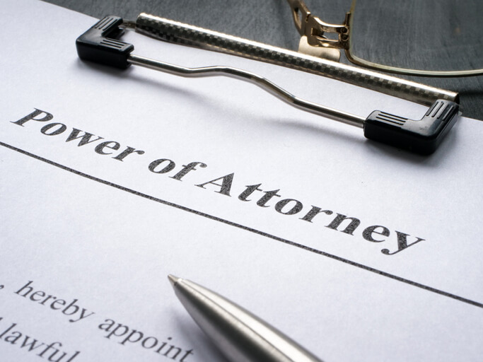 A Clipboard with Power of attorney and pen for signing.
