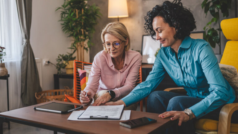 Two women work from home sign trust document in san mateo